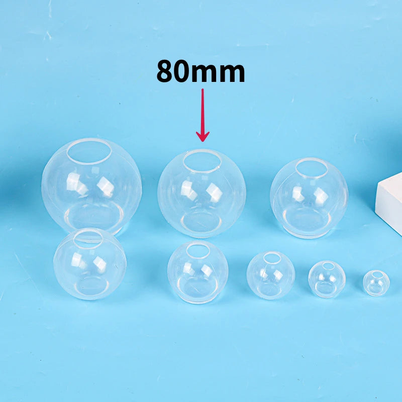 A set of clear silicone sphere molds for resin crafting, with a measurement indicator showing 80mm.