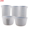 A set of white flexible silicone measuring cups with volume markings for resin and epoxy