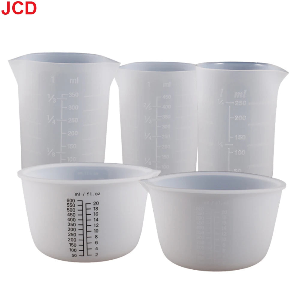 A set of white flexible silicone measuring cups with volume markings for resin and epoxy