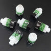 A set of seven floral resin potion bottle polyhedral dice, featuring green glitter accents and numbered faces.
