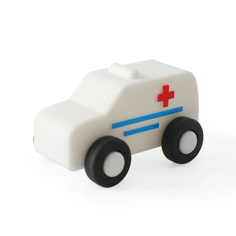 A white wooden and silicone car teether toy with blue stripes and a red cross on the side.