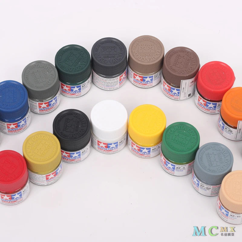 A collection of matte acrylic paint pots in various colors including green, brown, red, yellow, and gray.