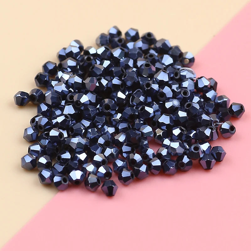 A pile of dark blue iridescent crystal glass beads for jewelry making