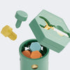 A green Montessori screwdriver board toy with various wooden accessories and a storage box.