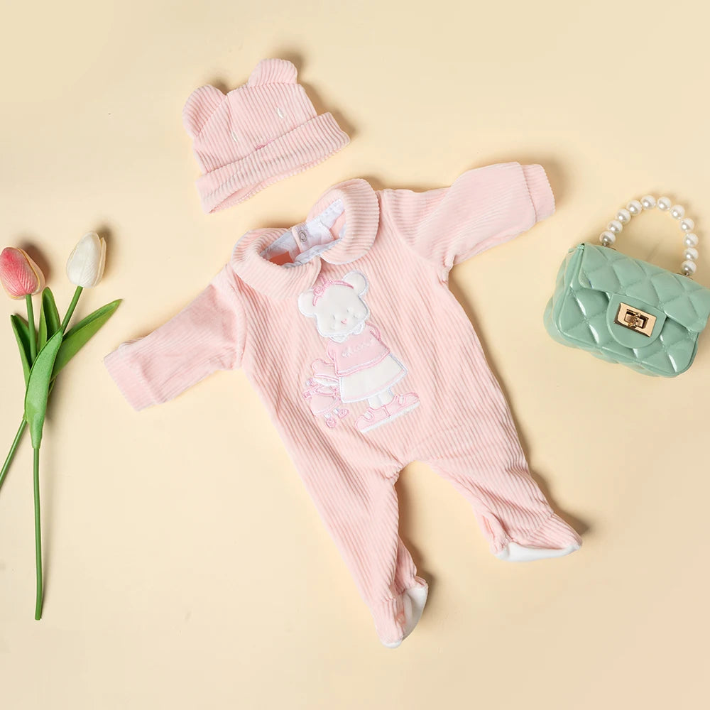 A pink knitted animal romper set for a baby doll, including a matching hat and a small green handbag.