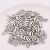A collection of 50 plastic seashell charms for jewelry making, featuring bohemian cowrie and conch pendants.
