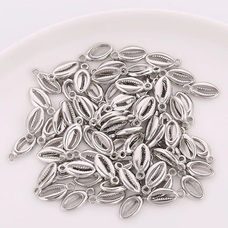 A collection of 50 plastic seashell charms for jewelry making, featuring bohemian cowrie and conch pendants.