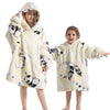Two children wearing fluffy cream colored flannel hoodies with black panda print designs