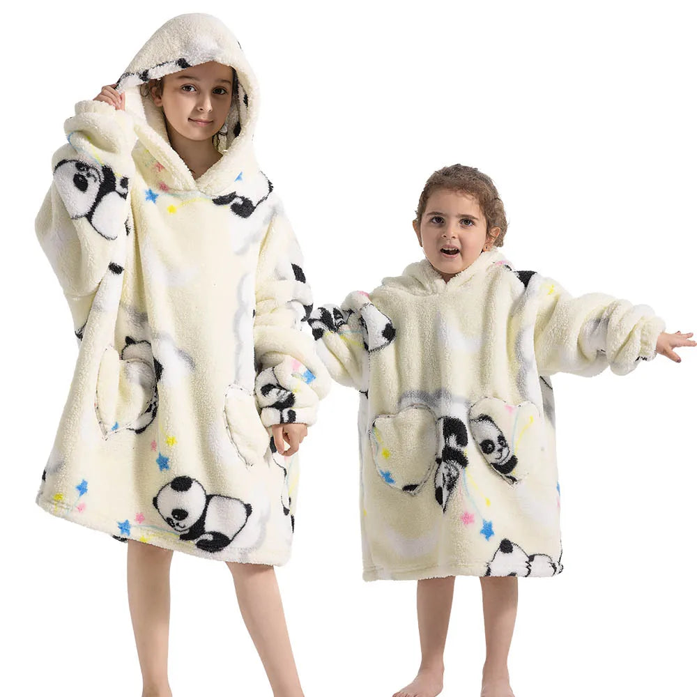 Two children wearing fluffy cream colored flannel hoodies with black panda print designs