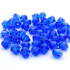 A pile of faceted blue crystal glass beads in various sizes for jewelry making