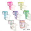 A collection of colorful acrylic alphabet beads in various shades of pink, green, and blue.