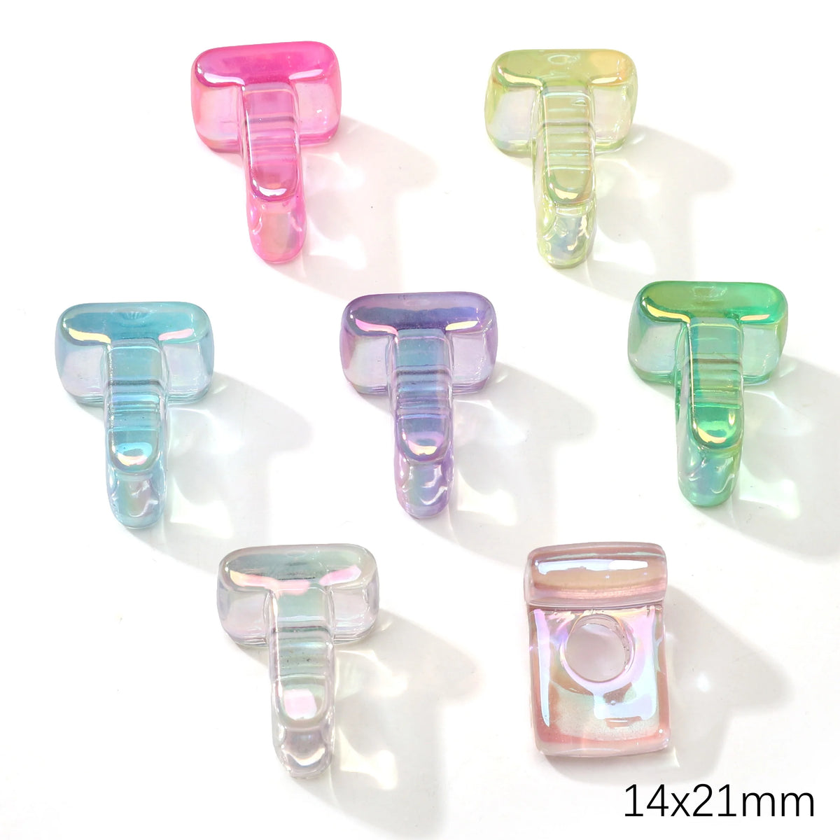 A collection of colorful acrylic alphabet beads in various shades of pink, green, and blue.
