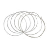A coil of silver-plated classical guitar strings with a transparent nylon core.