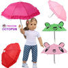 A mini doll plays with various colored umbrellas including pink, red, and green.