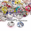A close-up of heart-shaped rhinestone flower charm beads in various colors and silver metal, showing different sizes.