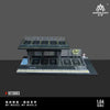 A 1:64 scale mini garage diorama featuring a black display shelf and several car parking spots.