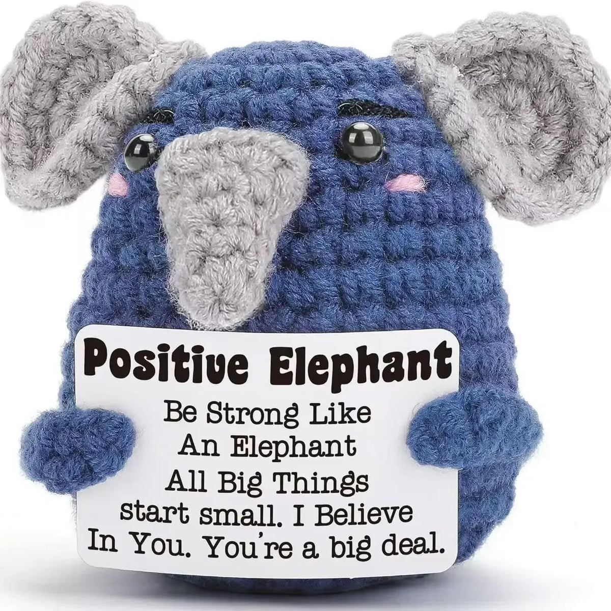 A handmade crochet elephant plush toy in blue and gray with an inspirational quote about believing in oneself.