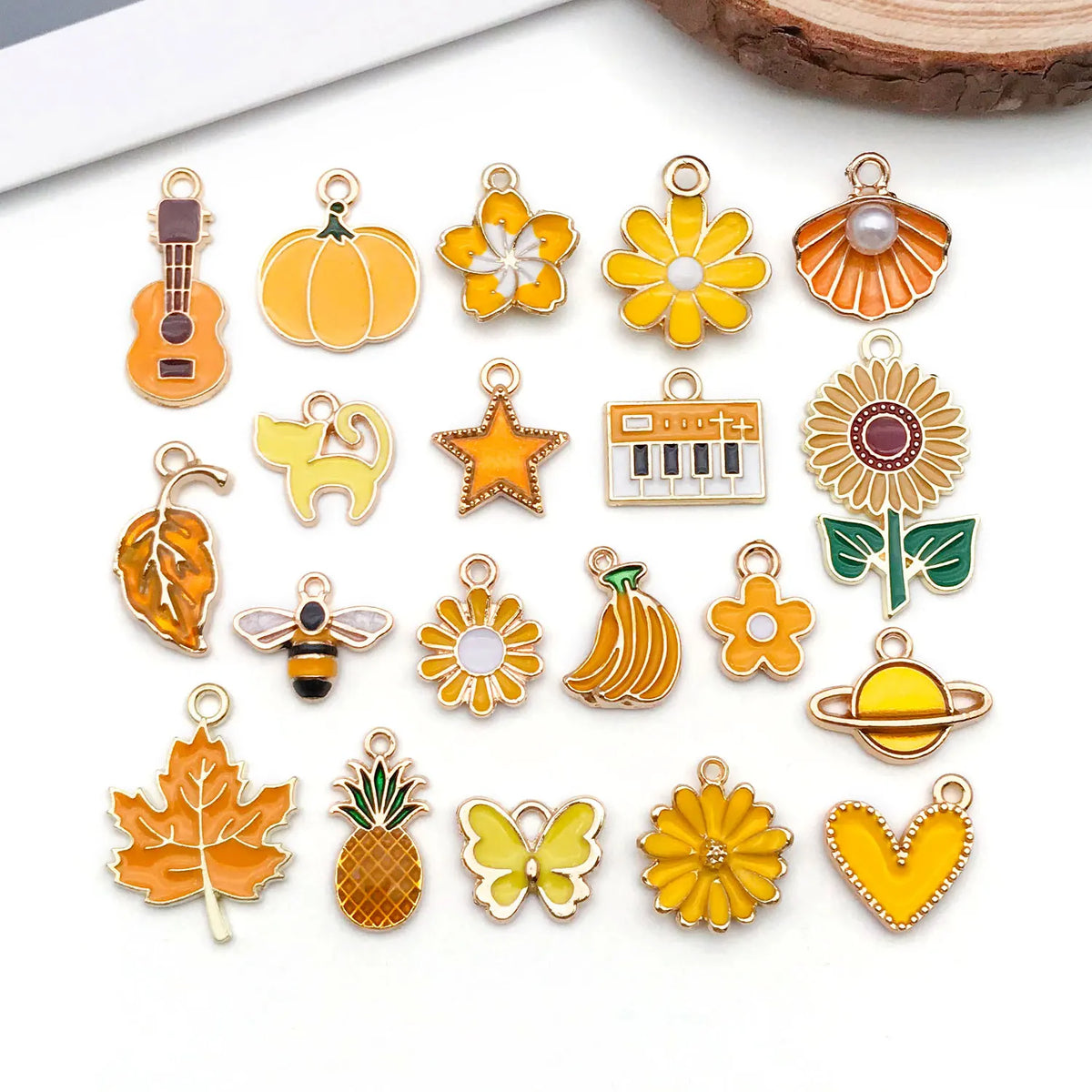 A collection of colorful enamel alloy flower charms featuring various shapes like pumpkins, stars, and leaves.