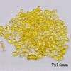 A pile of yellow glass beads shaped like tulip flowers, measuring 7x14mm.