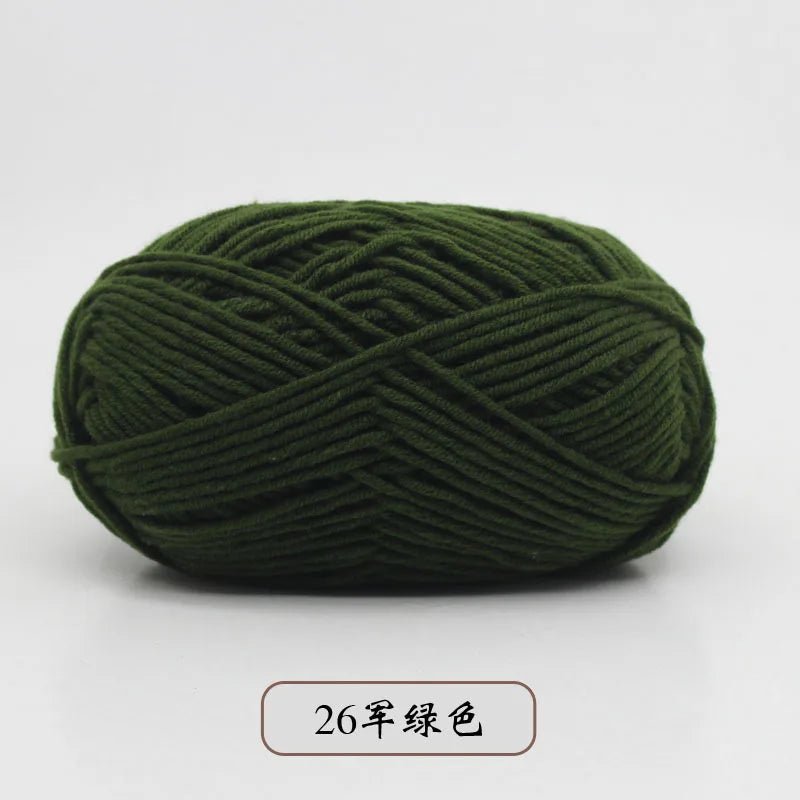 A ball of dark olive green pre-dyed milk cotton yarn for knitting and crochet.