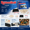 Box and components of the Classic Rummikub tile-racking strategy game including numbered tiles and black racks