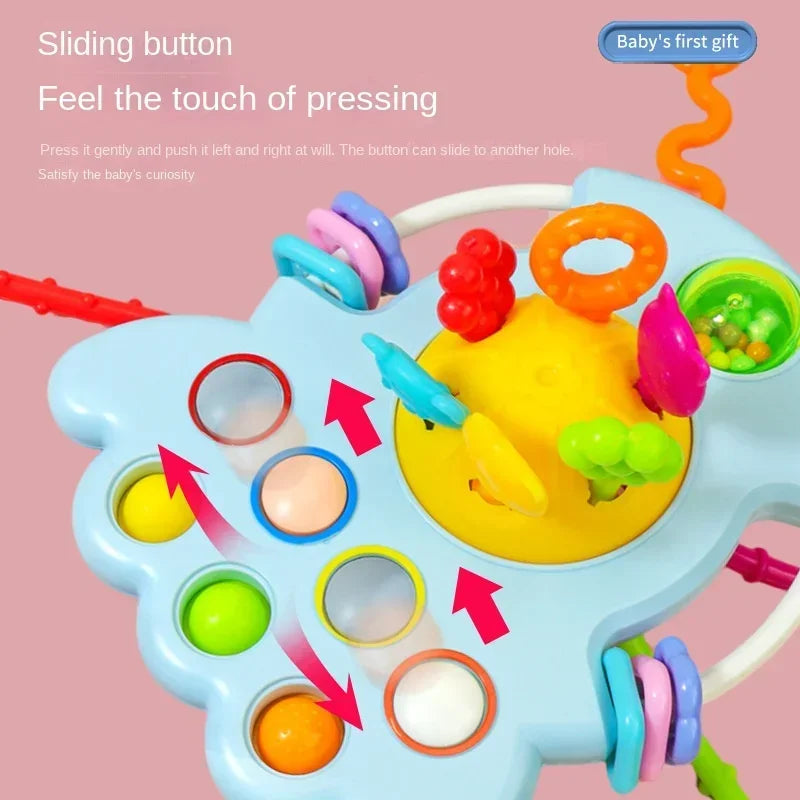 A blue sensory toy with various colorful parts and a sliding button for babies