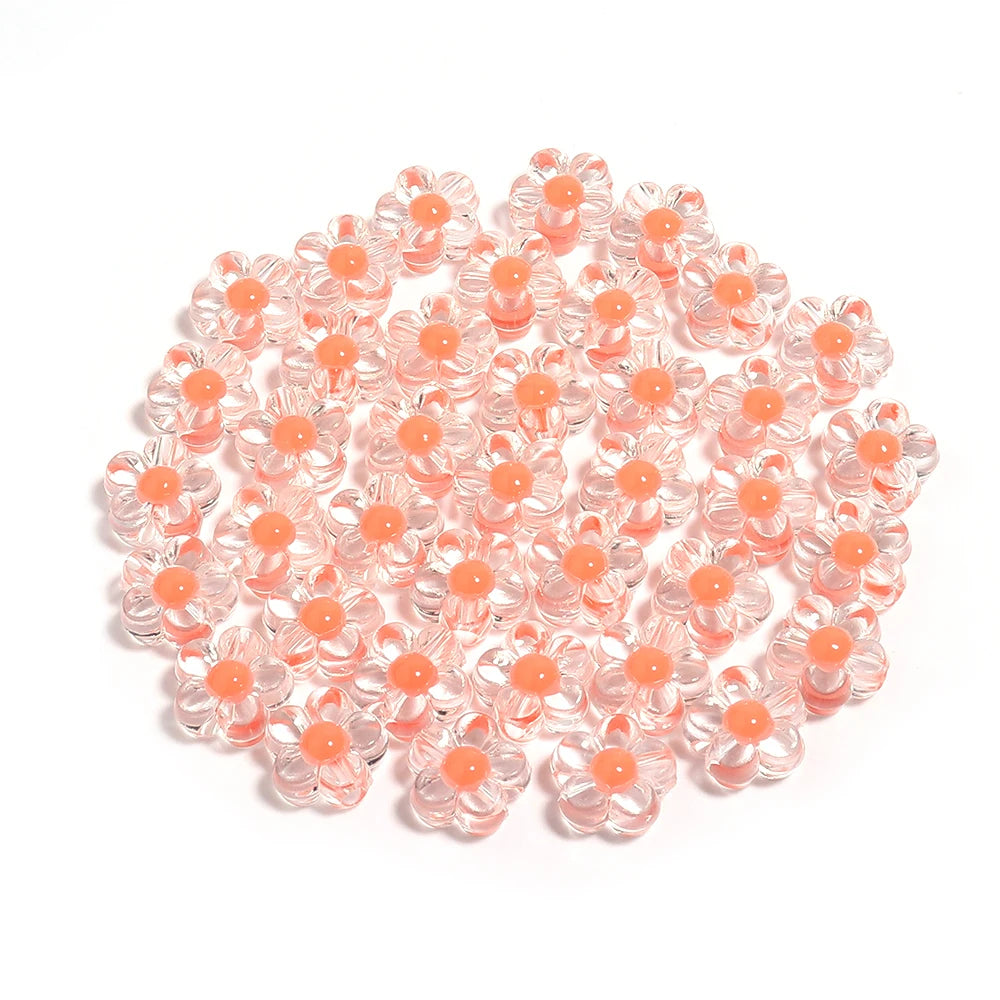 A pile of small, colorful transparent acrylic flower beads for DIY jewelry making.