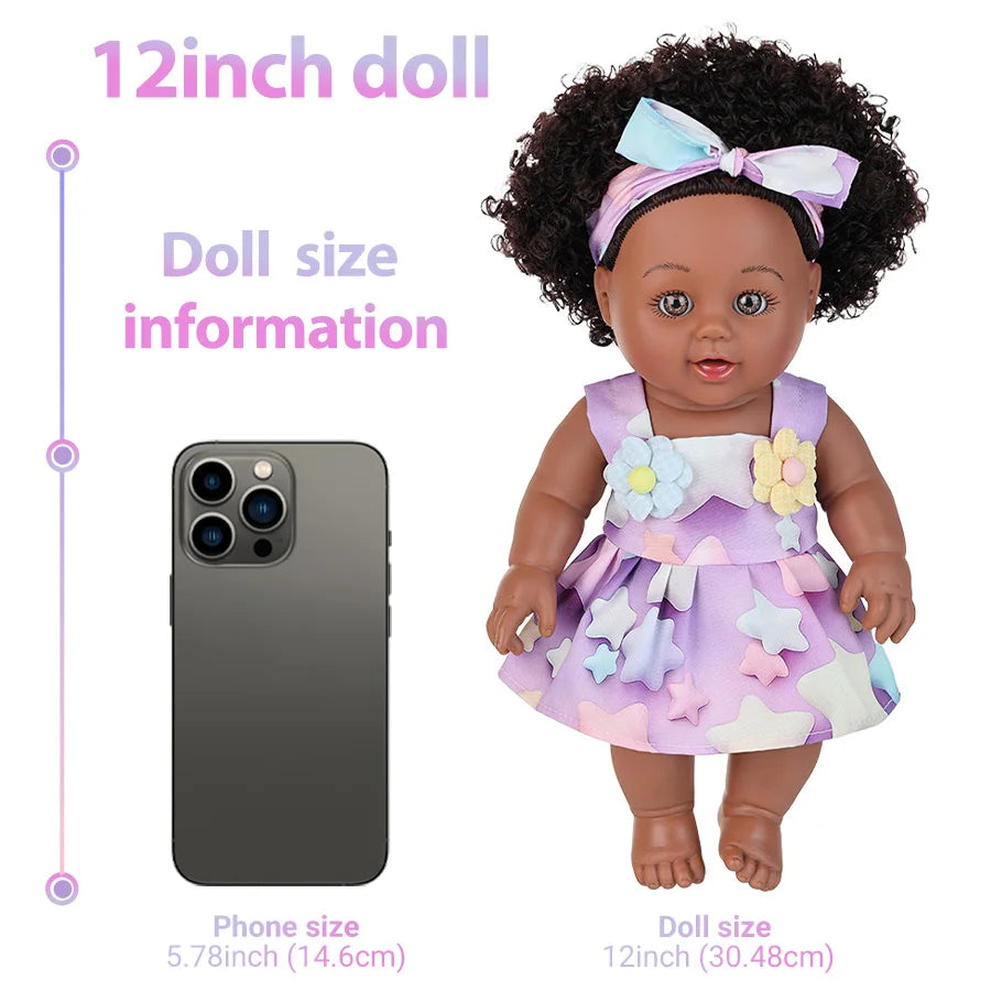 A 12-inch doll with dark curly hair wearing a purple dress and a bow, shown next to a smartphone for scale.