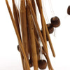 A close-up view of a set of flexible bamboo Tunisian crochet hooks with various sizes hanging together.