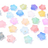 A collection of colorful transparent star acrylic beads in various pastel shades scattered on a white background.