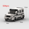A white and black die-cast model of a classic SUV or jeep building block set.