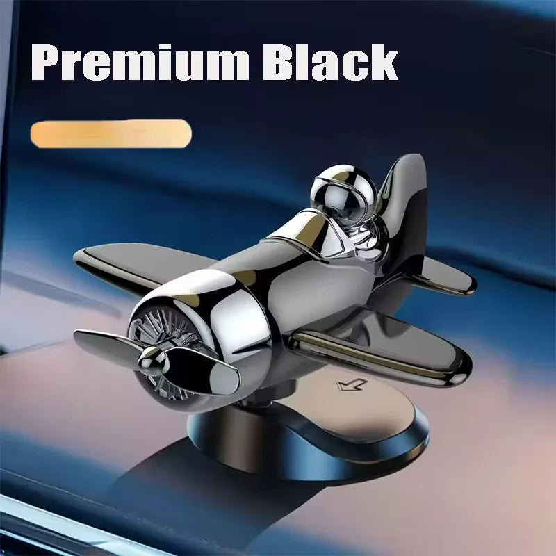A premium black solar powered rotating airplane dashboard ornament with a shiny metallic finish.