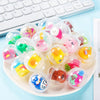 A collection of clear plastic capsule toys featuring mixed animal and cartoon figures for party favors