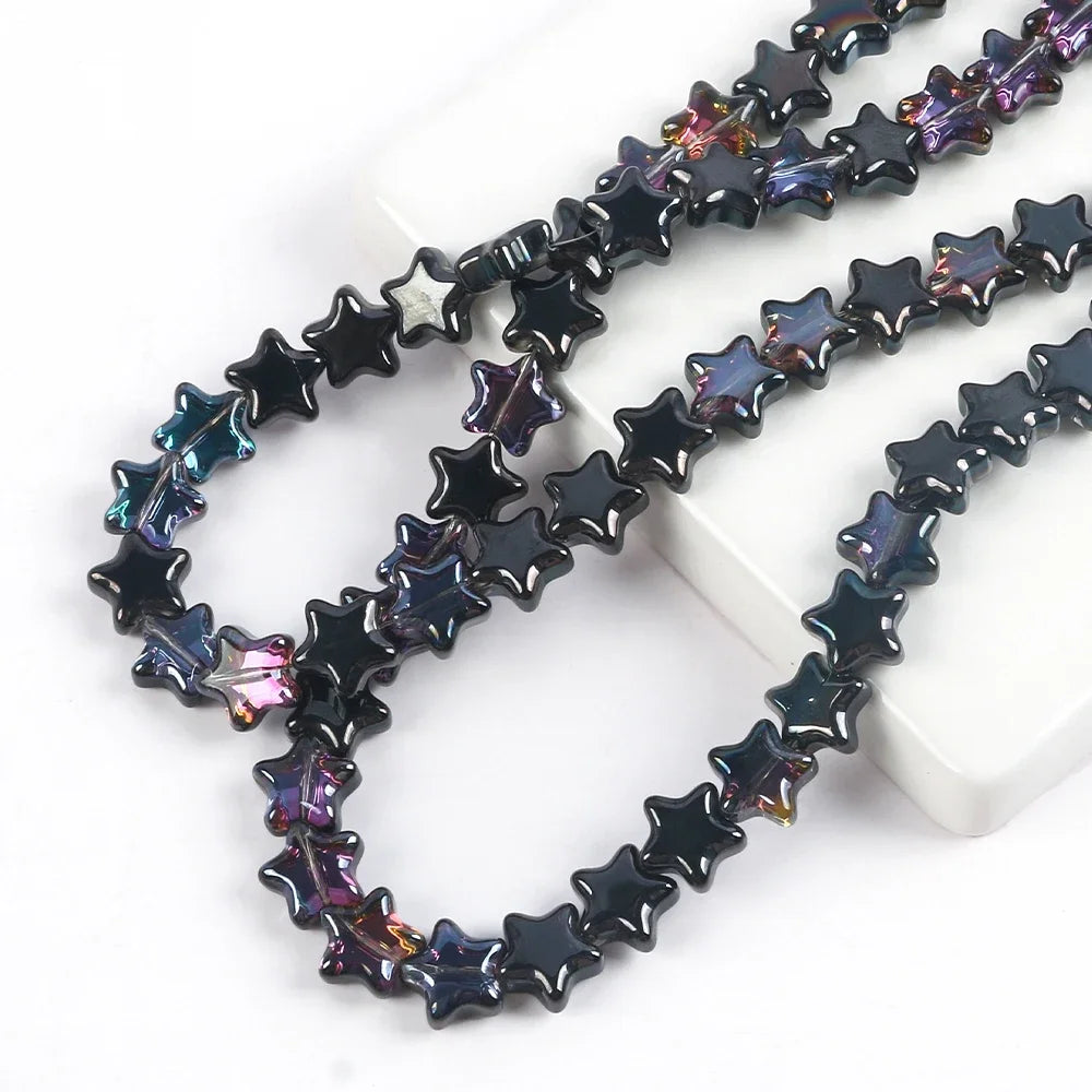 A strand of dark iridescent glass star spacer beads for jewelry making