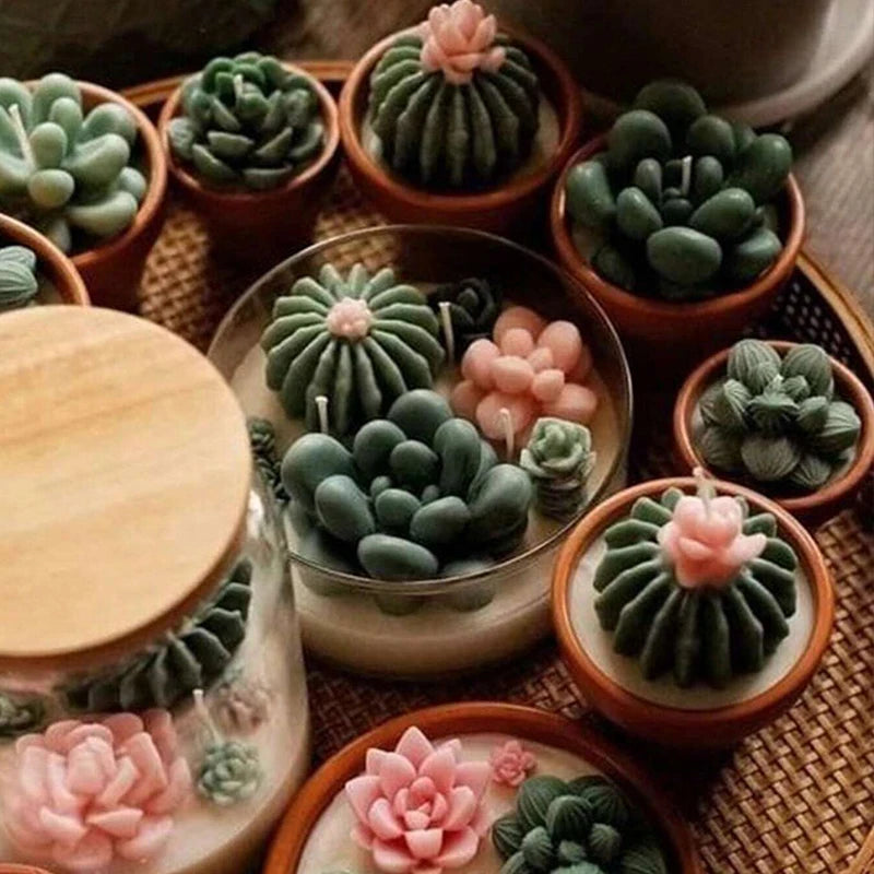 A collection of green and pink silicone cactus and succulent molds used for crafting candles, soap, and plaster