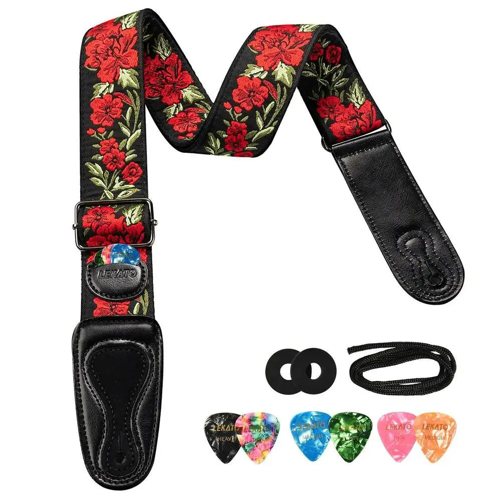 Vintage floral guitar strap with picks and strap locks featuring red and green patterns.