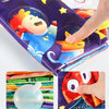 A purple sensory cloth book featuring a cartoon character, with close-ups of crinkled pages and colorful fabric.