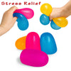 A hand is squeezing a bright pink squishy stress relief ball and a blue one, with other colored balls scattered below.
