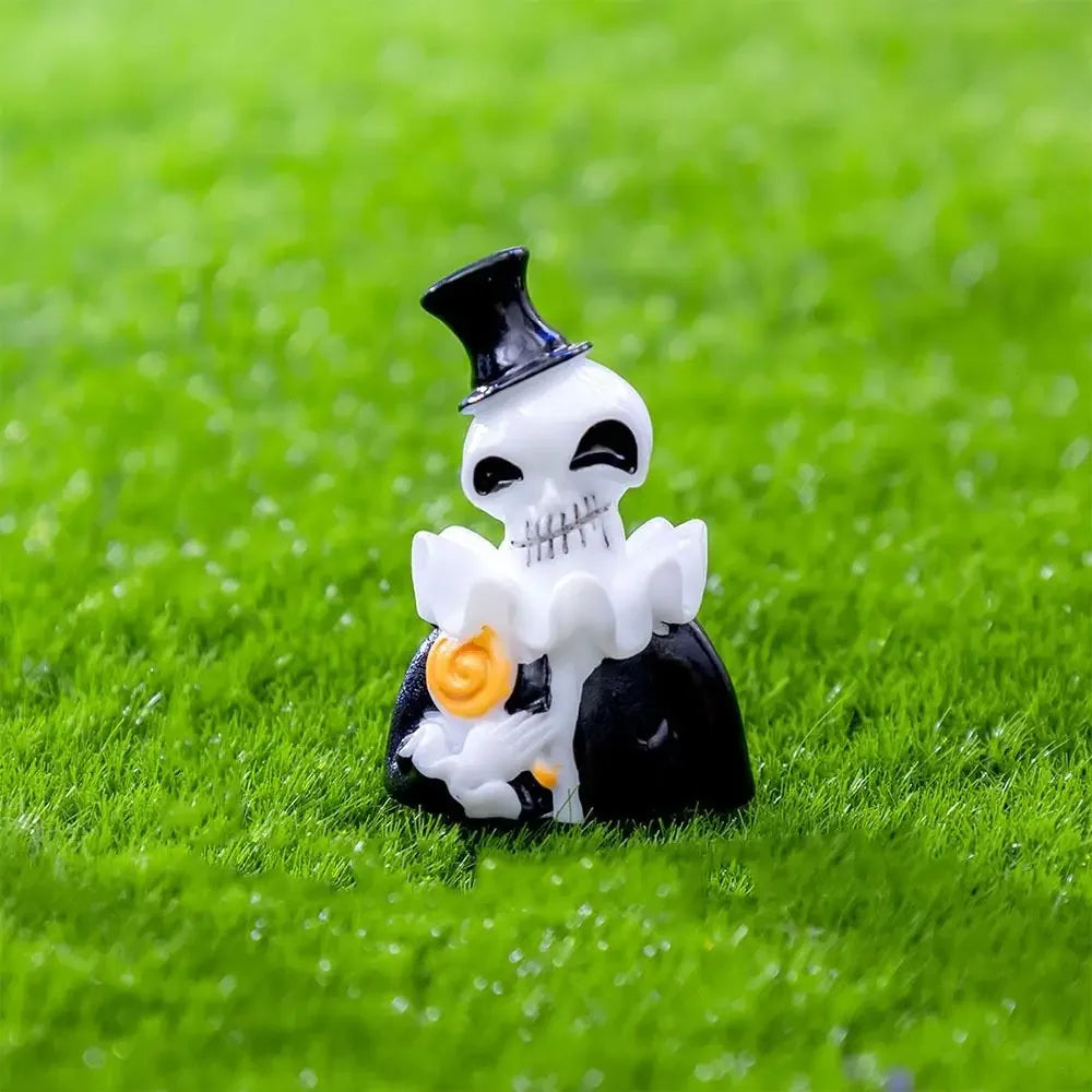 A white skull figure wearing a black top hat and holding a gold coin, set against bright green grass.