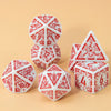 A set of seven polyhedral dice in white and red are arranged on a light beige surface.