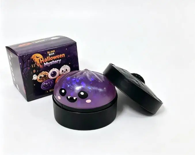 A black squishy stress relief toy with purple glow and a box labeled Halloween Mystery.