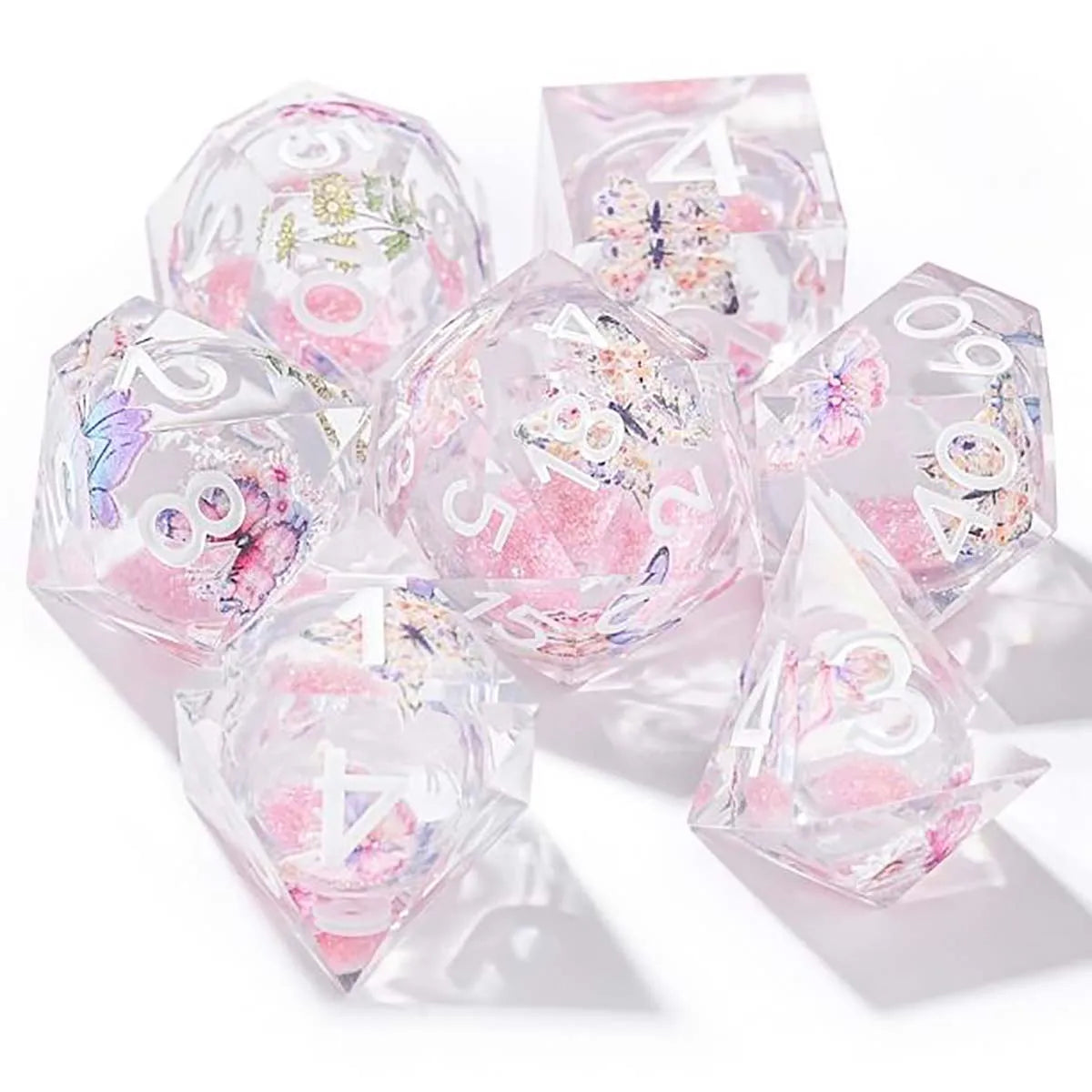 A set of seven pink floral butterfly resin polyhedral dice for tabletop role-playing games