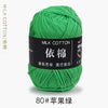 A ball of bright green milk cotton yarn labeled with Chinese characters and the number 80