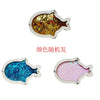 A silver-framed fish charm covered in gold glitter and a pink fish charm covered in pink glitter.