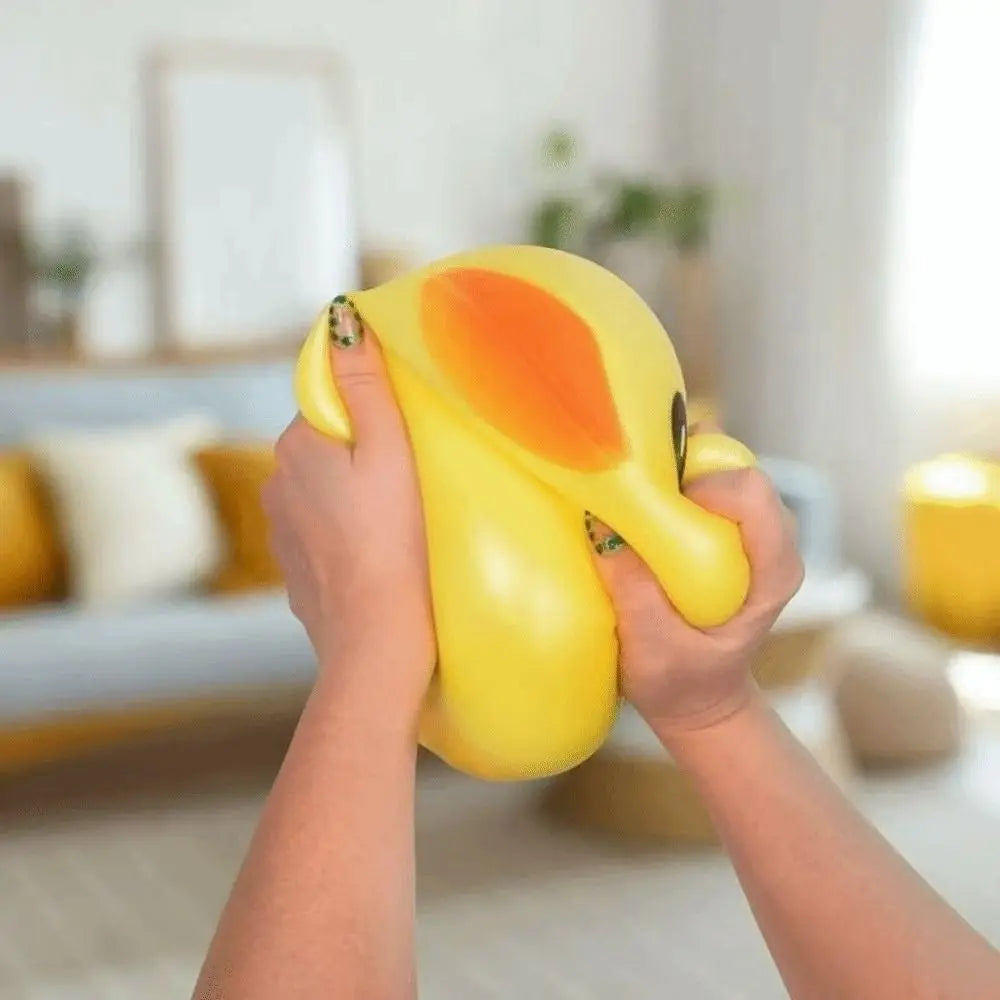 A person is squeezing a large, yellow, duck-shaped stress relief toy.