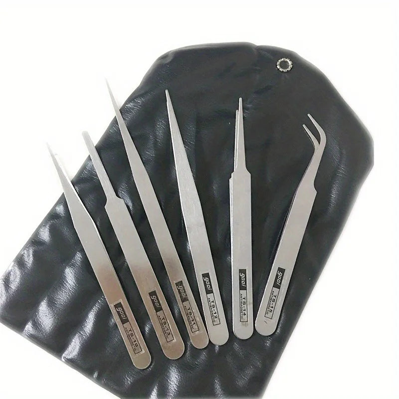 A set of six stainless steel precision tweezers with straight and bent tips resting on a dark leather surface.