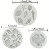 A set of silicone baking molds shaped like various seashells and starfish for ocean-themed crafts.