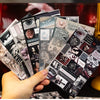 A hand holds a stack of die-cut sticker sheets featuring retro day and night poetry for journaling and scrapbooking.