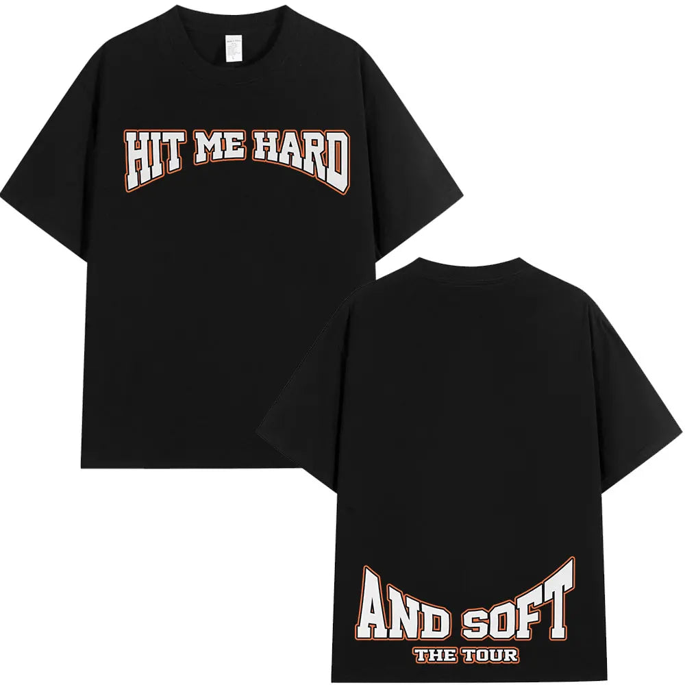 Black t-shirt with 'HIT ME HARD' and 'AND SOFT THE TOUR' text printed in orange on the front.
