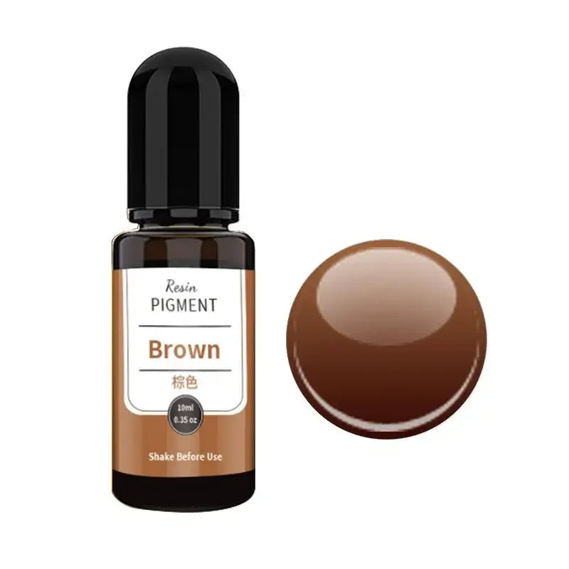 A small glass bottle of brown resin pigment with a round brown pigment bead next to it.